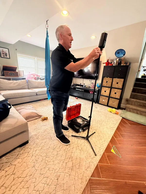 Inspector setting up an air sampling pump for an indoor mold test in Philadelphia